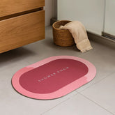 Tapete de baño ovalado 40×60 cm rosa “SHOWER ROOM” vista frontal