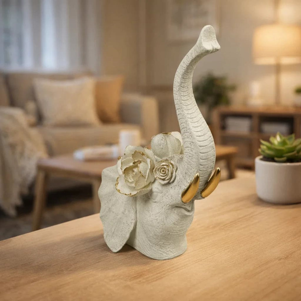 Figura decorativa elefante blanco con detalles florales y colmillos dorados