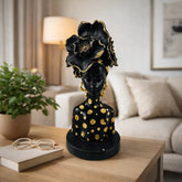 Figura decorativa mujer africana con vestido animal print y cabello floral negro