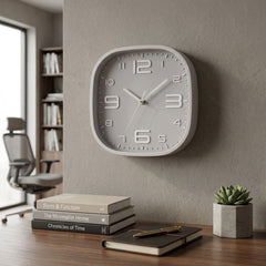 Reloj de pared cuadrado gris con borde y números blancos