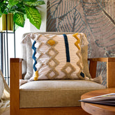 Cojín Rustic 104 multicolor 45×45 cm con diseño geométrico y borlas