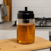 Frasco de vidrio para miel 130ml con tapa negra y aplicador