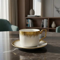 Set plato con pocillo blanco con dorado diseño sol y asa geométrica dorada