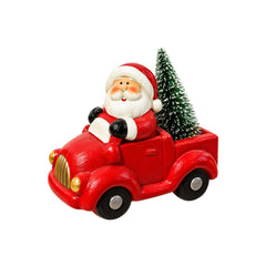 Figura navideña de carro rojo con personaje y árbol de Navidad