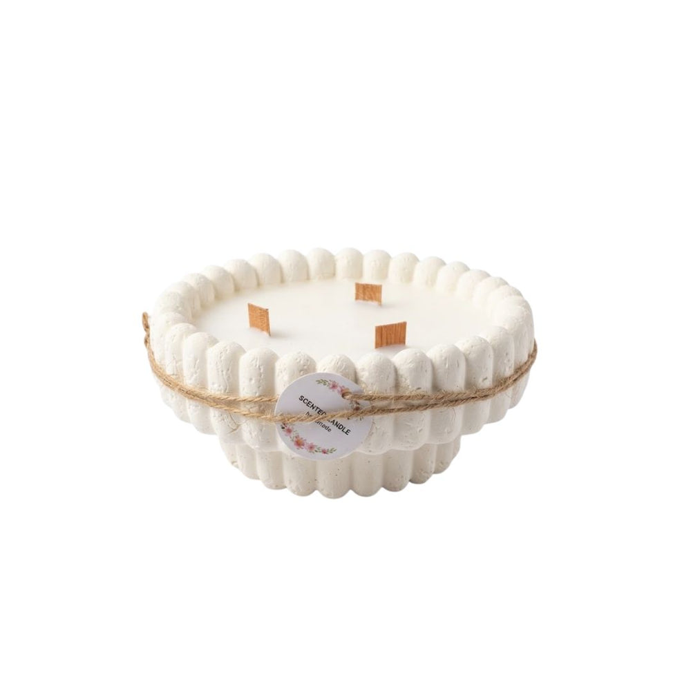 Vela artesanal circular blanca con borde ondulado y tres mechas